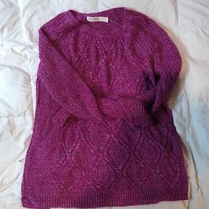 A purple, knitted sweater